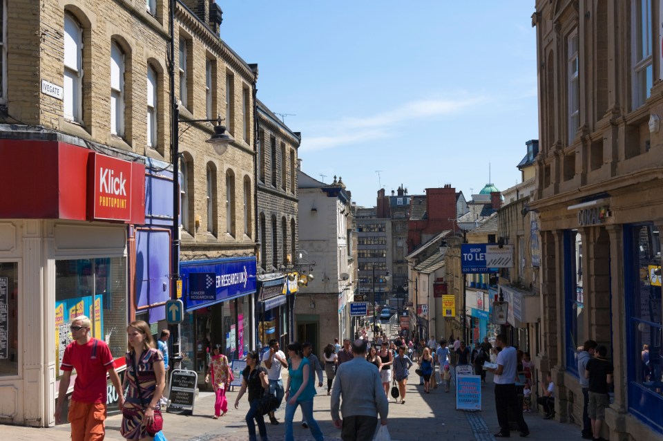 Pedestrians shopping on Ivegate in Bradford, England.