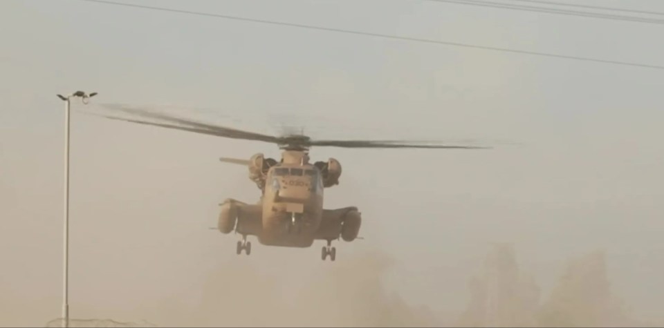 TV news screen grab showing a Red Cross helicopter en route to collect hostages from Hamas.