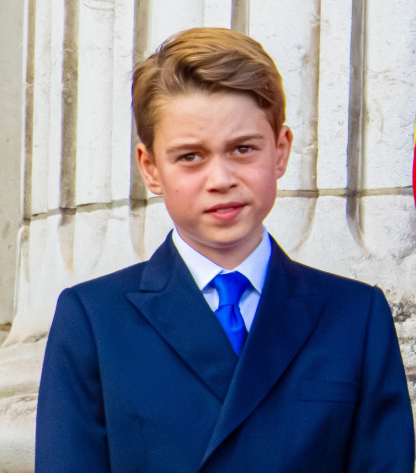 Prince George in a navy blue suit.