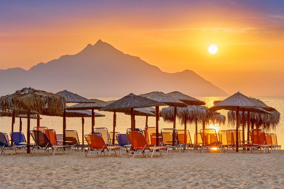 Sunrise over Halkidiki beach with Mount Athos in the background.