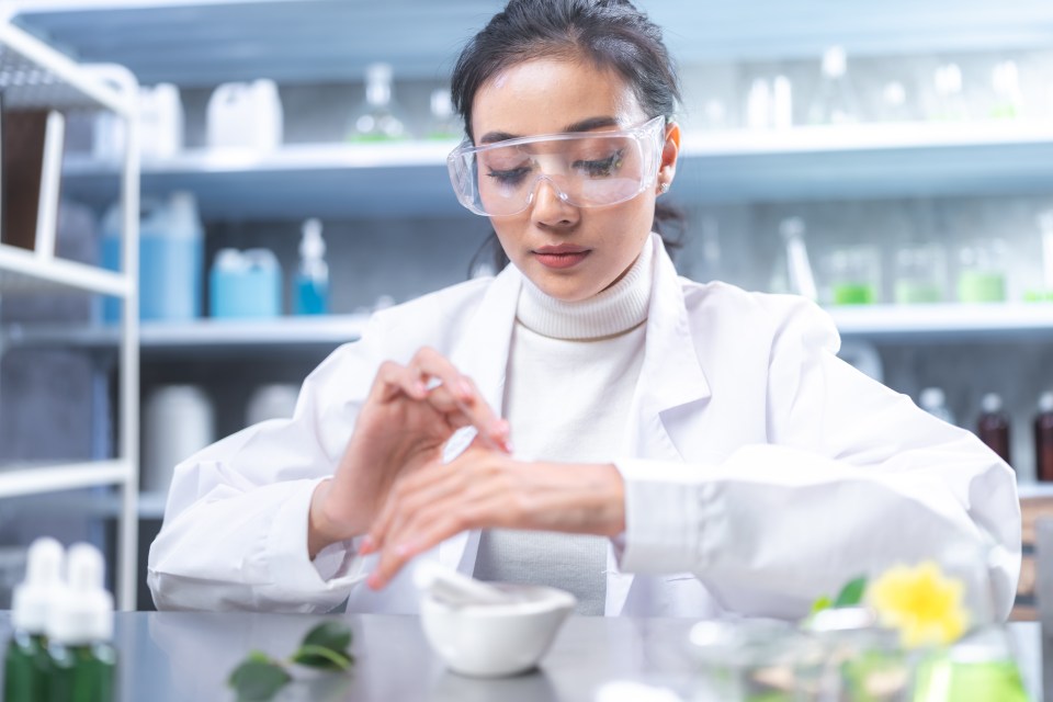 Scientist testing cosmetic product in a lab.