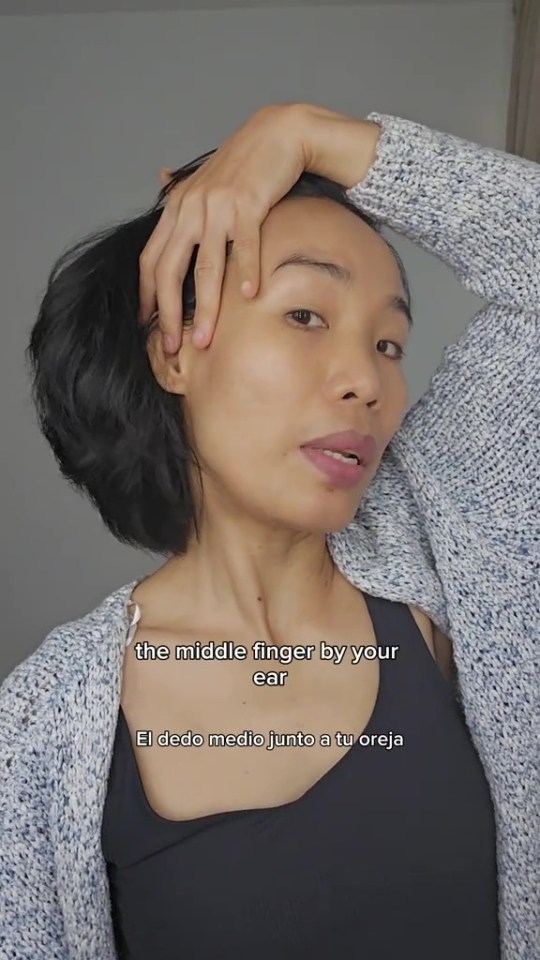 Woman demonstrating a facial stretch.