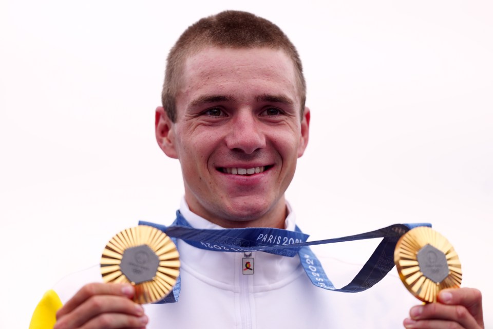 Remco Evenepoel holding two gold medals.