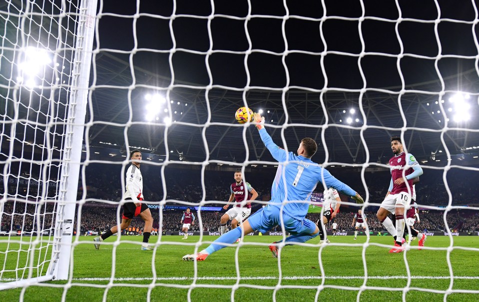 Soccer goalie diving to unsuccessfully block a goal.