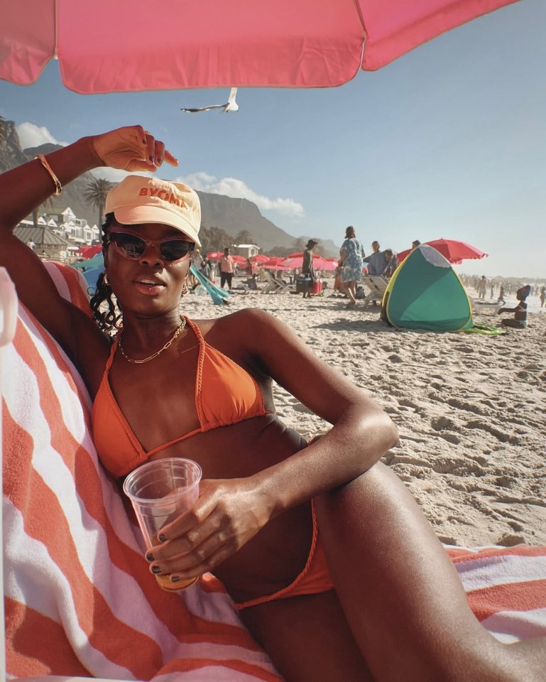 AJ Odudu relaxing on a South African beach in a bikini.