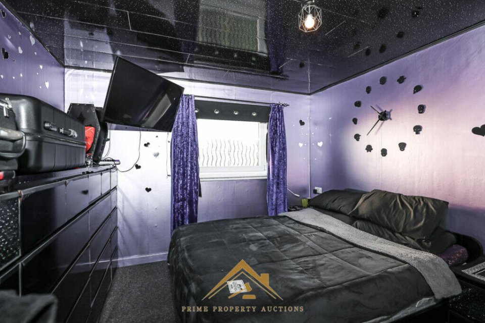 Bedroom with black and purple decor.