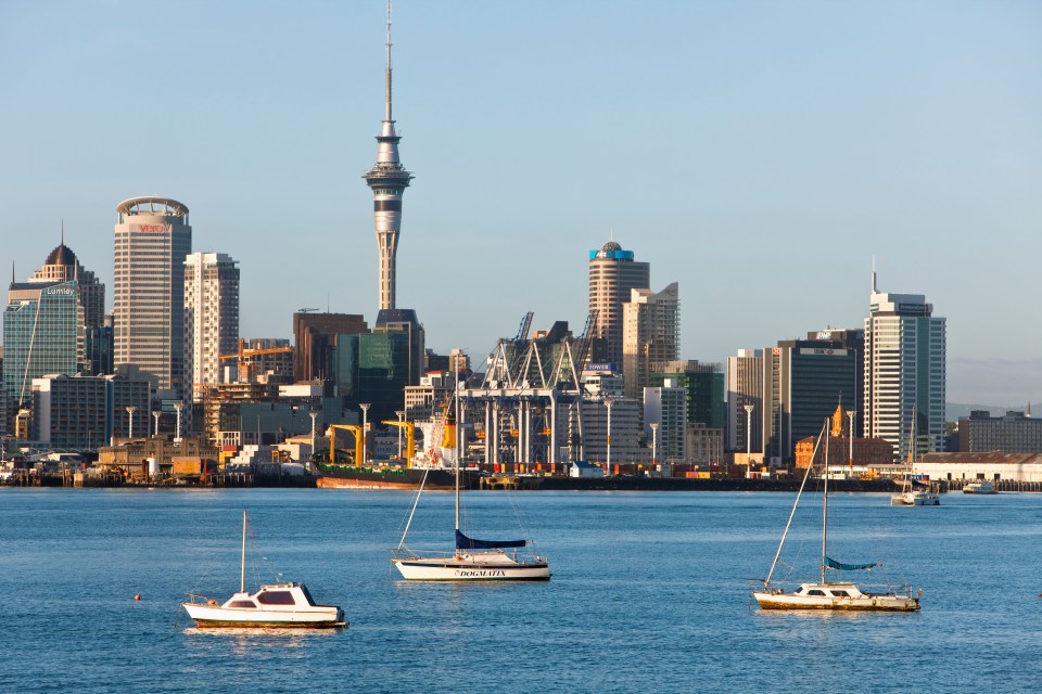 Auckland city skyline with boats in the harbor.