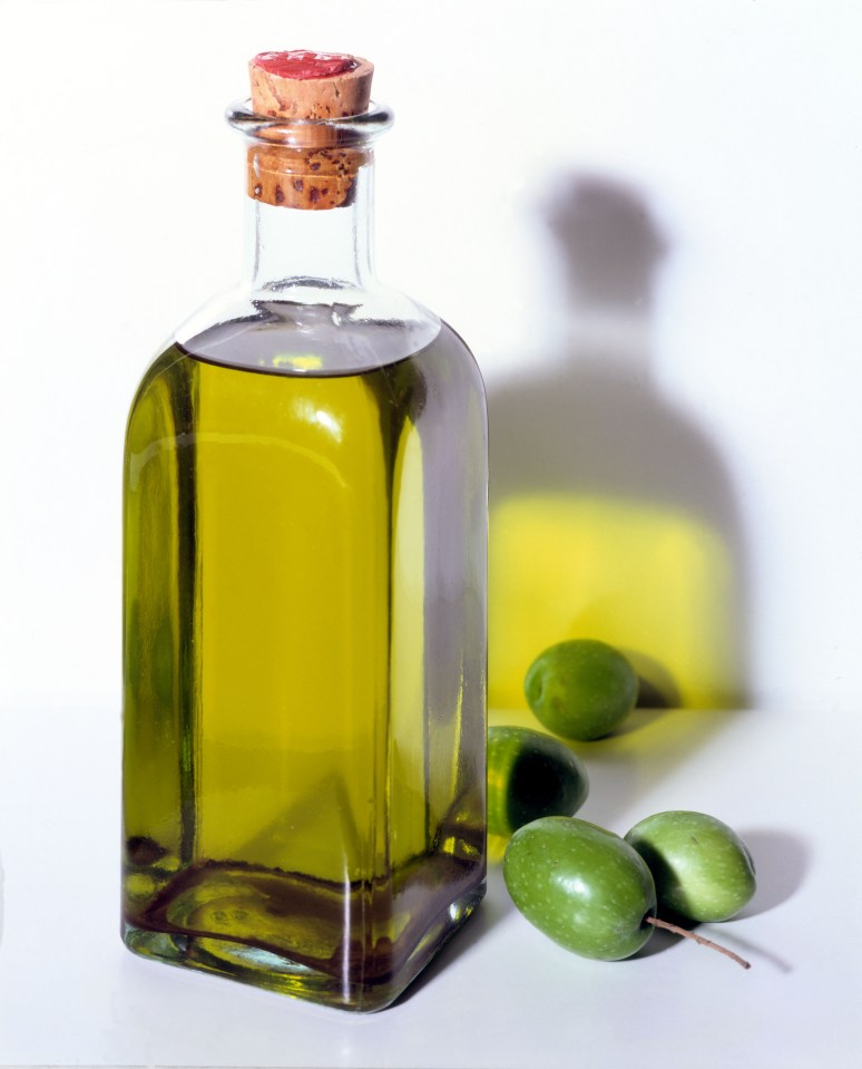 Bottle of olive oil and olives.