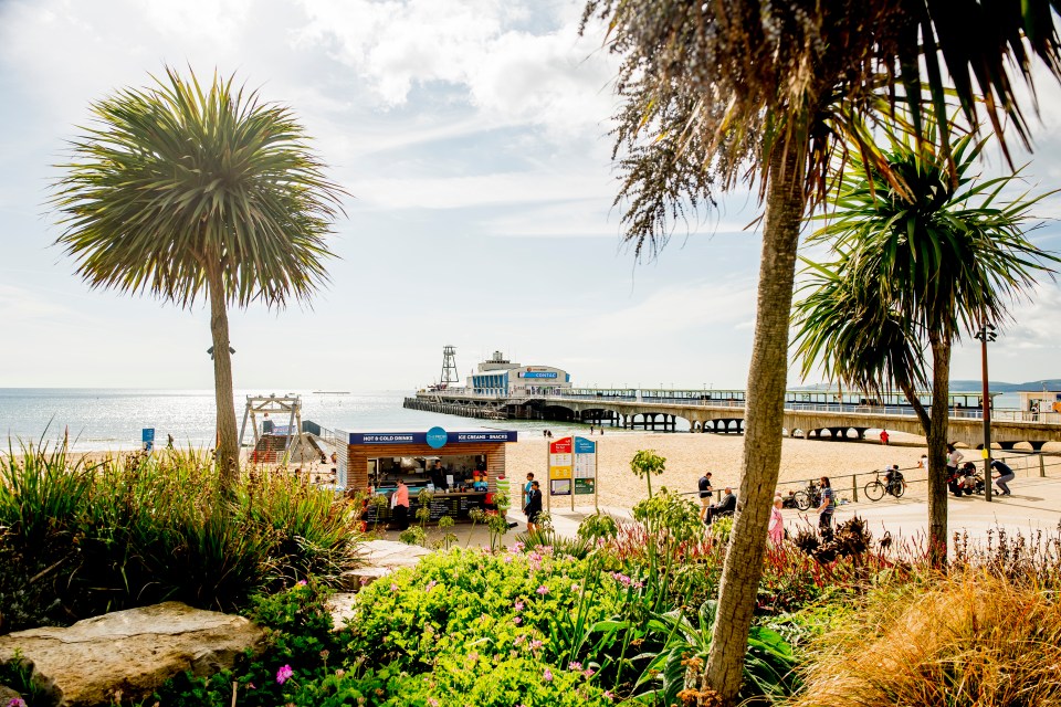 Bournemouth beach scene with pier and snack stand.