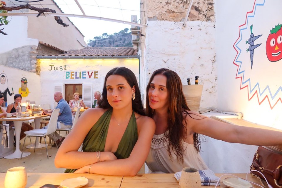 Claudia Raia and her daughter Sophia Raia sitting at a table outdoors.