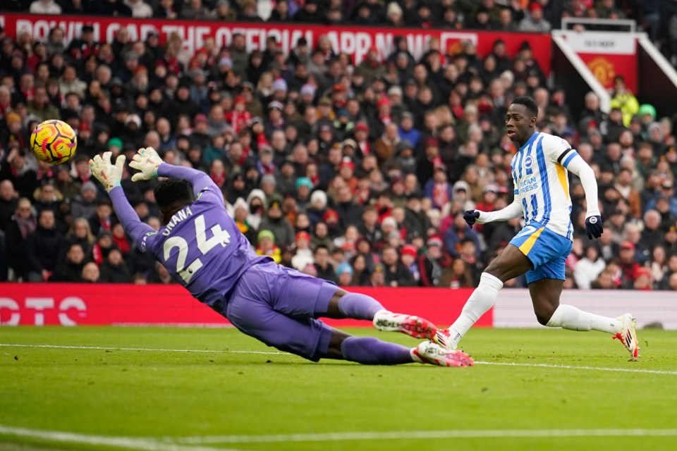 Yankuba Minteh scoring a goal against Manchester United's goalkeeper.