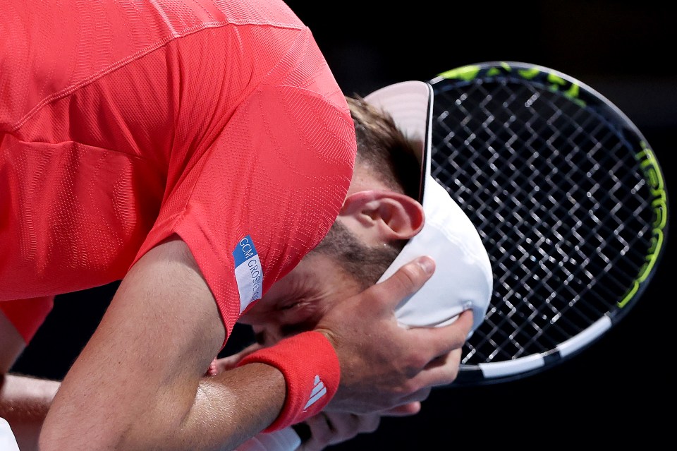 Jacob Fearnley of Great Britain in distress after losing a tennis match.