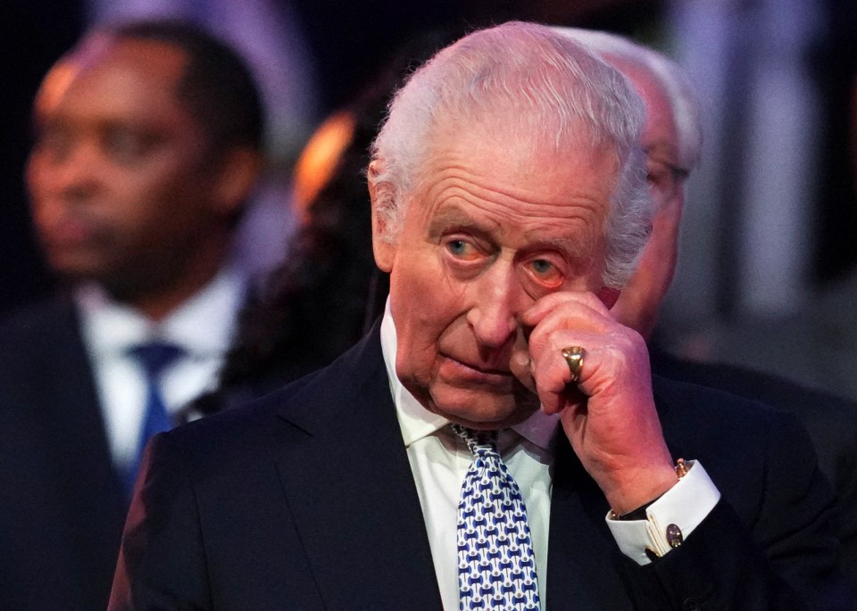 King Charles III wiping a tear at an Auschwitz liberation commemoration.