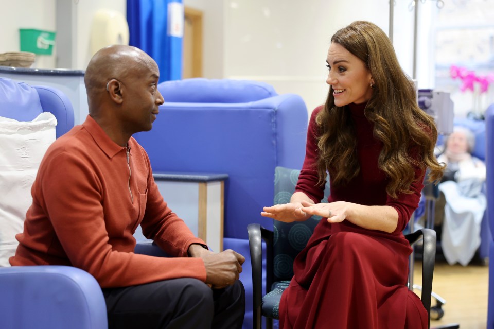 Princess Kate speaking with a man at a hospital.