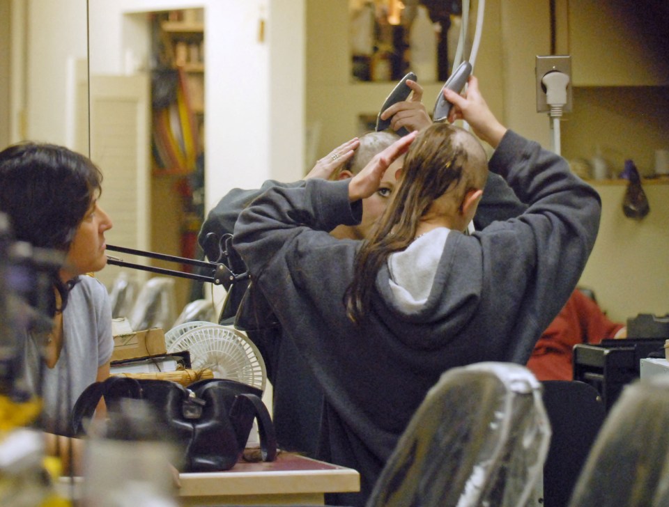 Britney Spears shaving her head at a hair salon.