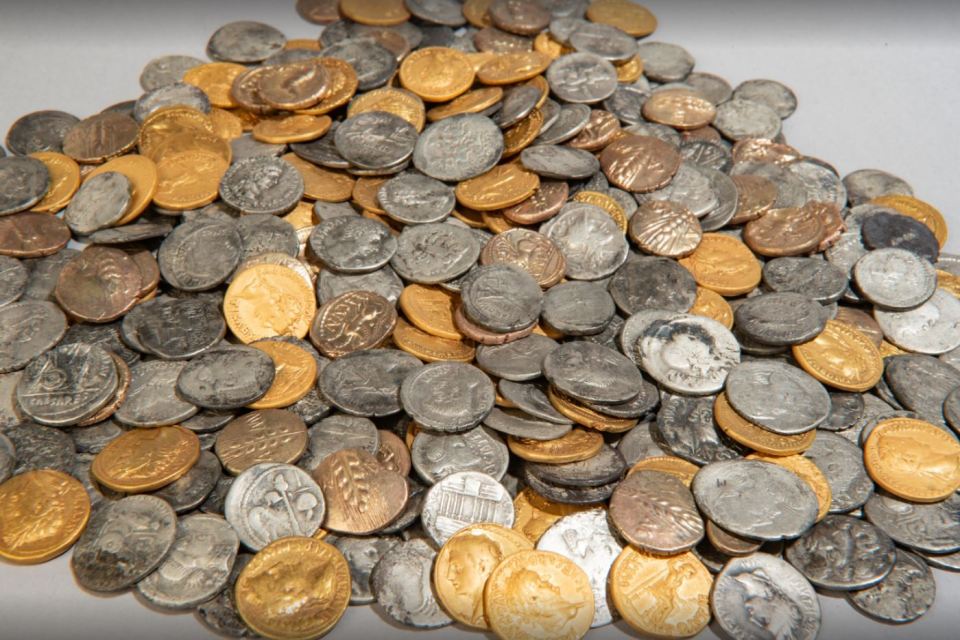 A large pile of ancient gold and silver coins.