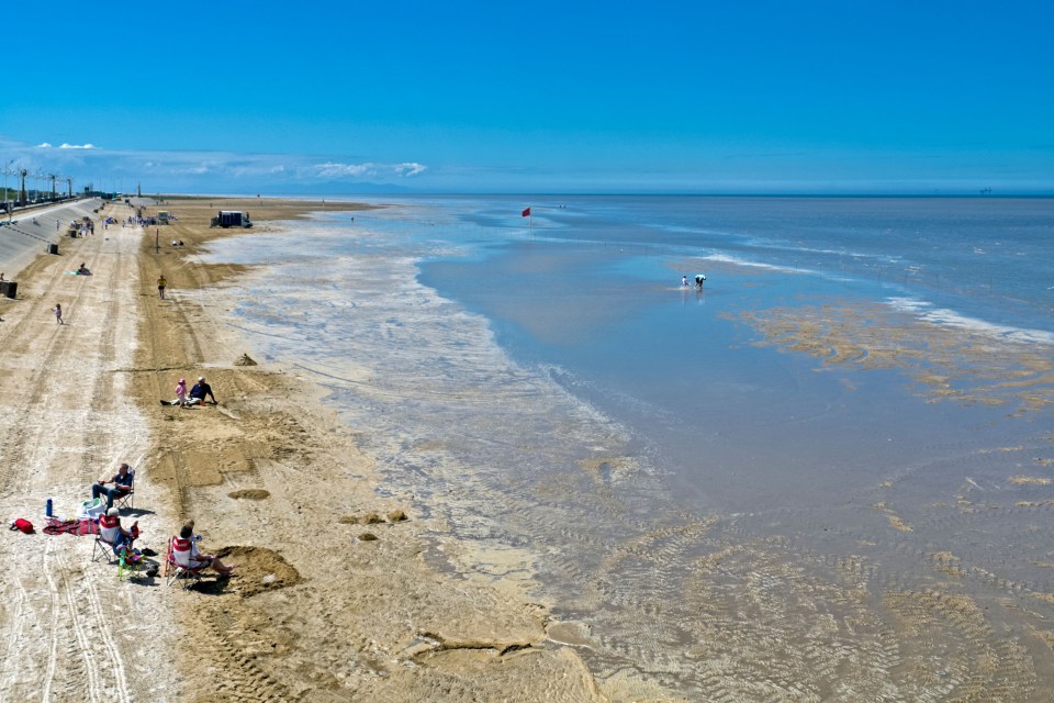 Southport beach with people relaxing and playing on the sand.