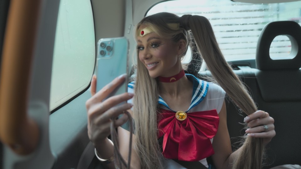 Woman in Sailor Moon costume taking a selfie in a car.