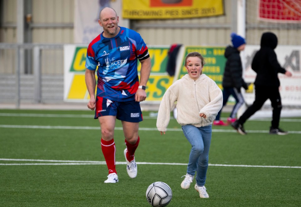 Mike Tindall playing football with his daughter.