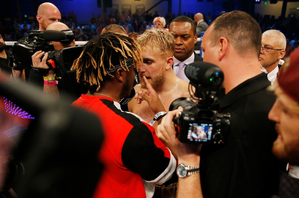 Jake Paul and KSI arguing after a boxing match.