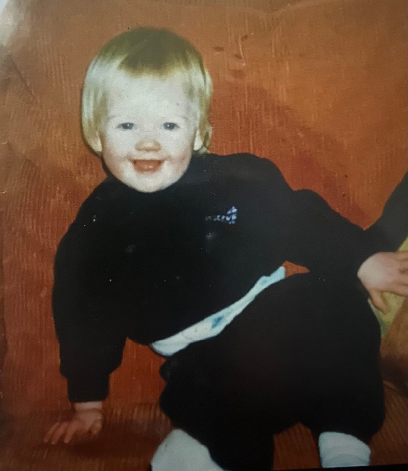 Photo of a toddler sitting on a couch.