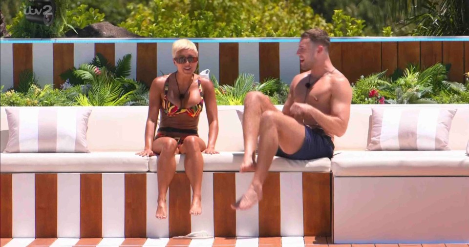 Kaz Crossley and Curtis Pritchard chatting on a Love Island set.