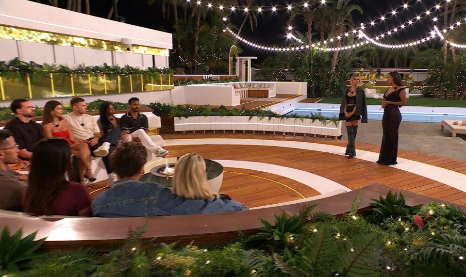 Islanders gathered around a fire pit for a Love Island challenge.