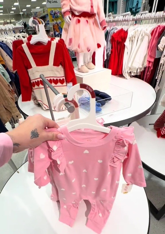 Pink baby outfit with white hearts.