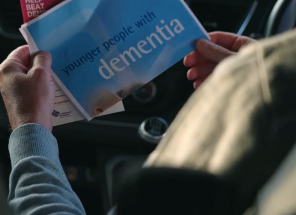 Person reading a pamphlet about younger people with dementia.