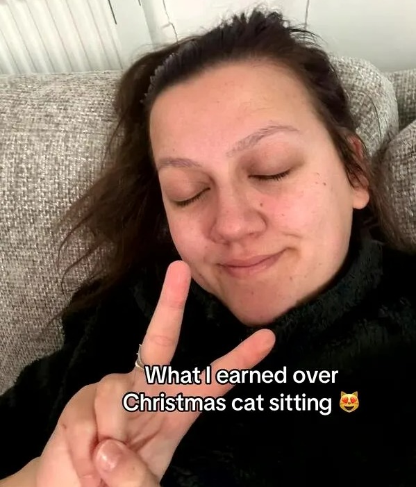 Woman showing peace sign, text overlay: "What I earned over Christmas cat sitting"