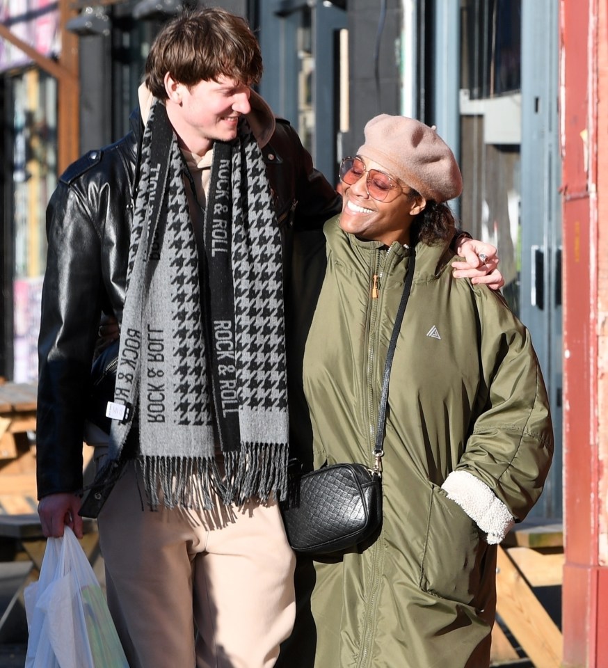 Alison Hammond and David Putman walking together, smiling.