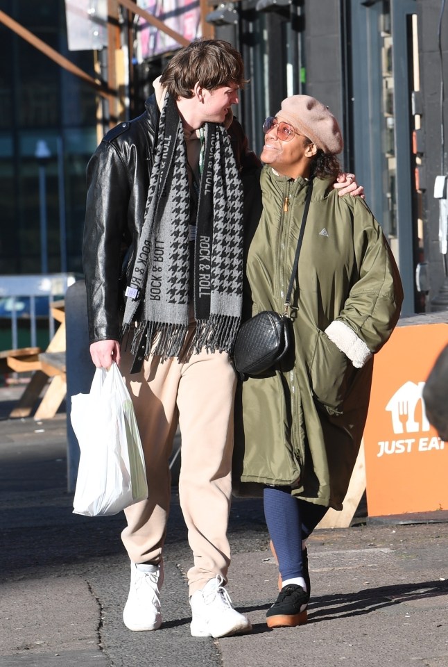 Alison Hammond and David Putman walking and holding hands.