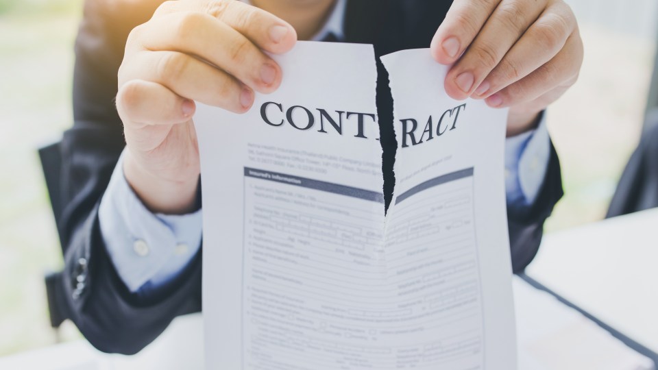 Businessman tearing up a contract.