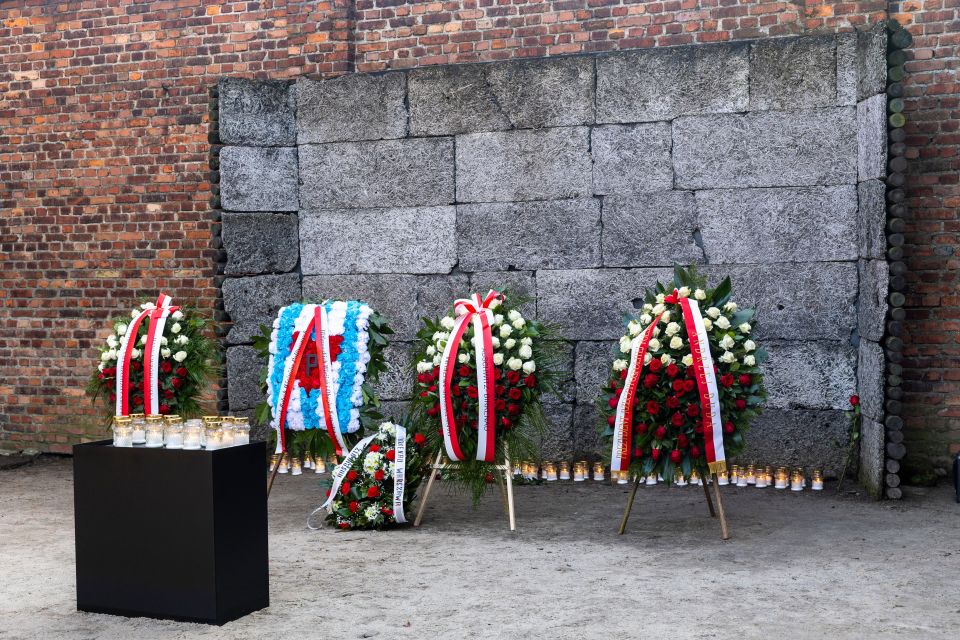 Wreaths and candles at the Auschwitz-Birkenau death wall.