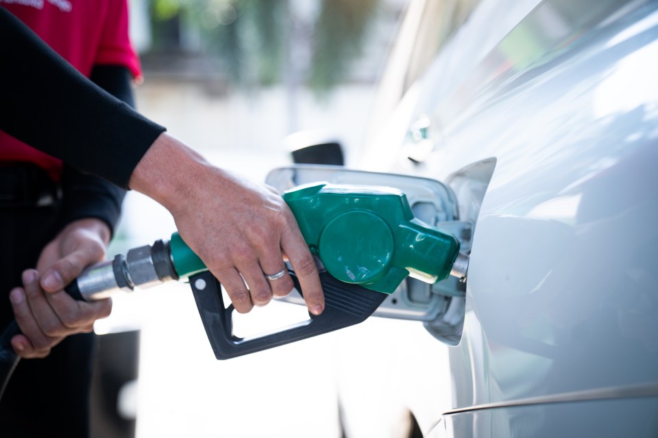 Person refueling a car.