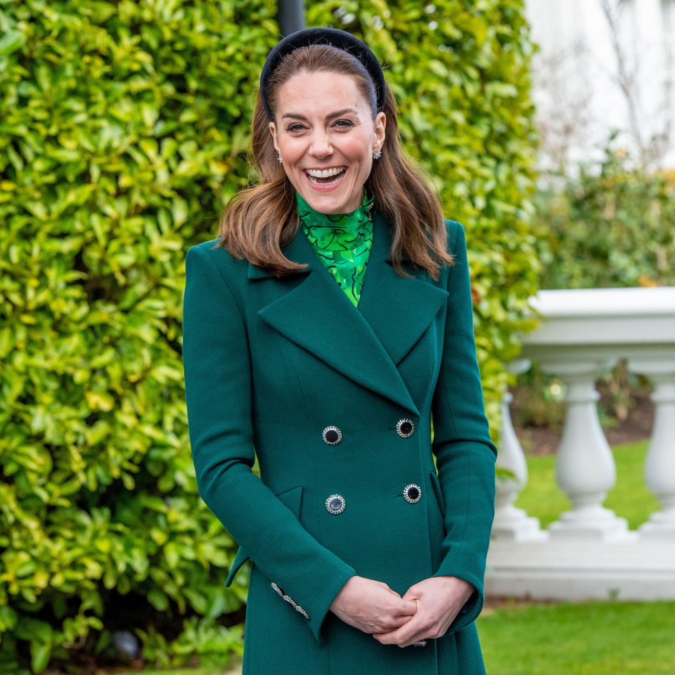 Catherine, Princess of Wales, smiling in a green coat.