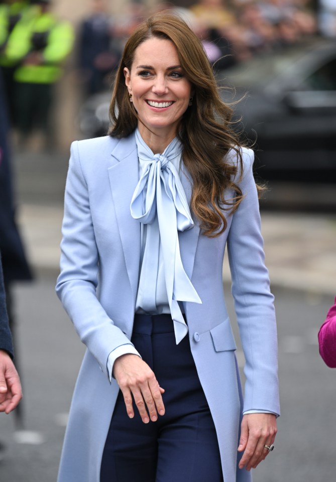 Catherine, Princess of Wales, in a light blue suit.