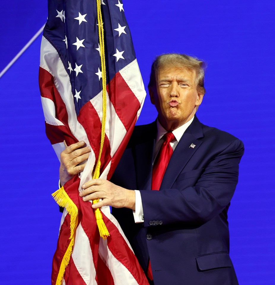 Donald Trump holding an American flag at CPAC.