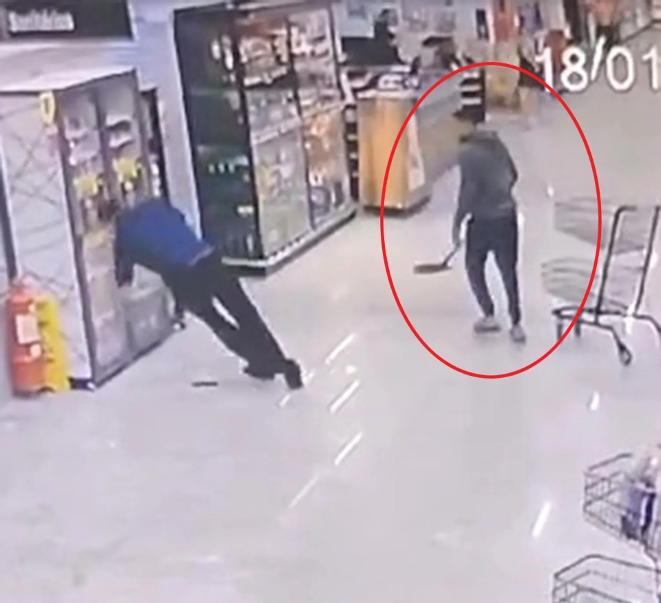 CCTV footage of a man hitting another man in the head with a shovel in a supermarket.