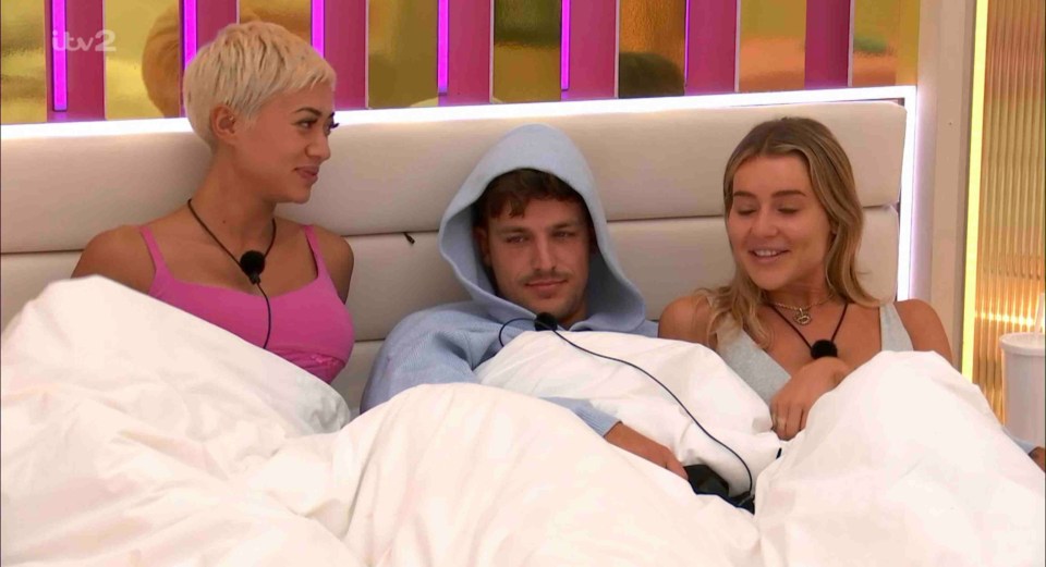 Kaz Crossley, Luca Bish, and Tina Stinnes in bed together.