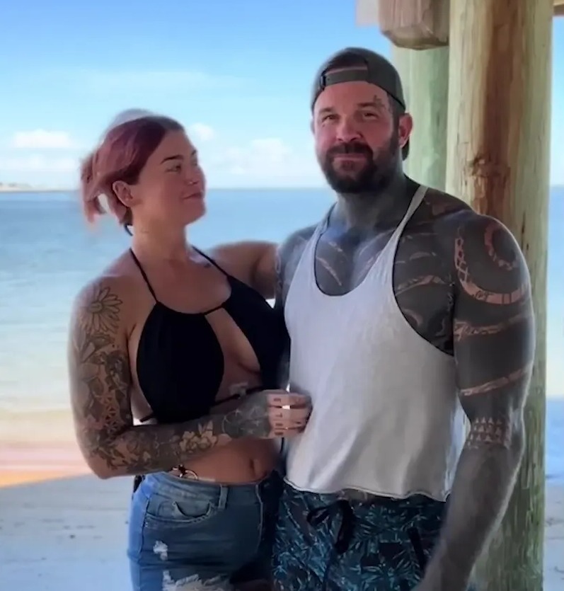 Couple on beach refuting the claim that bisexual men don't exist.