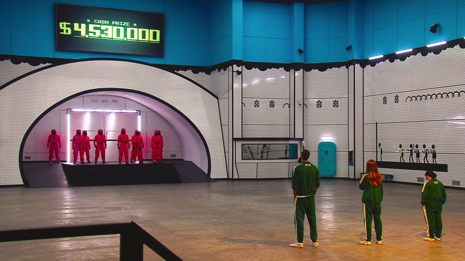 Squid Game: The Challenge set showing contestants and a $4,530,000 cash prize sign.