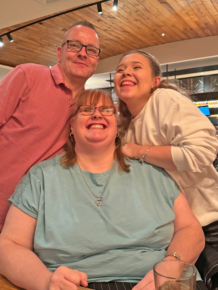 Photo of three people smiling for a photo.