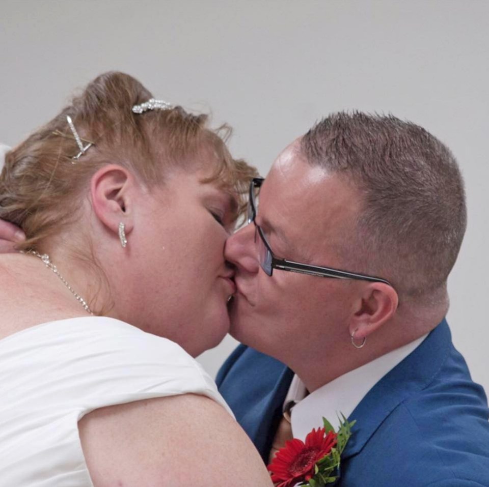 A bride and groom kissing.