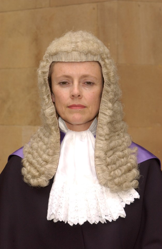 Portrait of a female judge in a wig and robe.