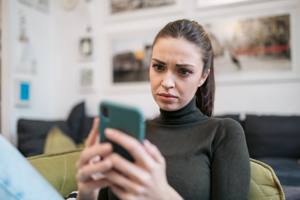 Sad woman looking at her phone.