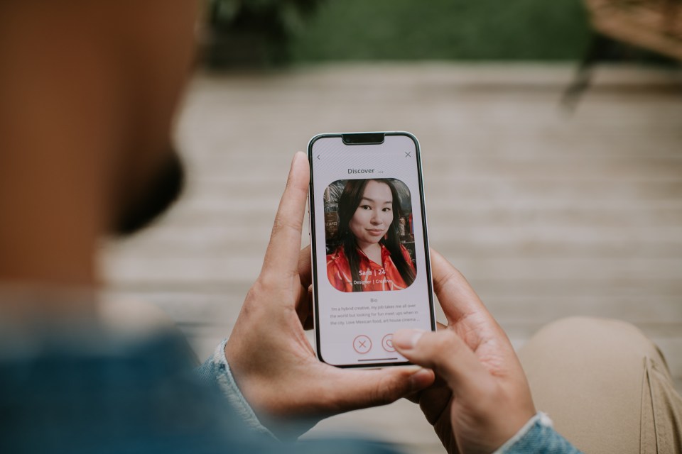 Person using dating app on smartphone.