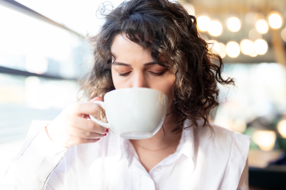 Woman enjoying a cup of coffee.