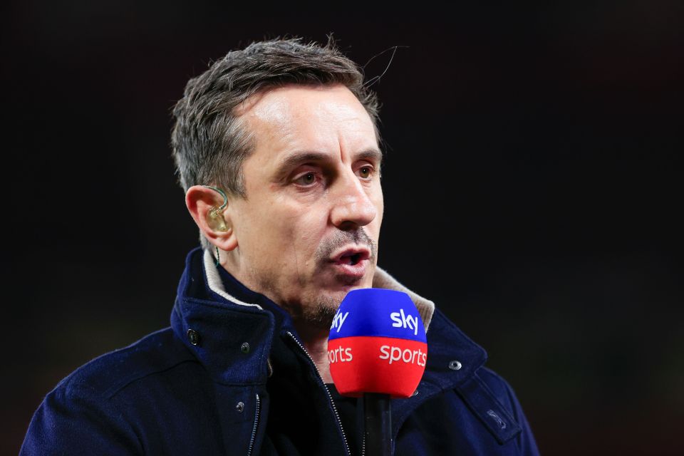 Gary Neville speaking into a Sky Sports microphone.