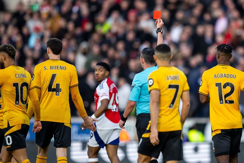 Referee showing a red card to a soccer player.